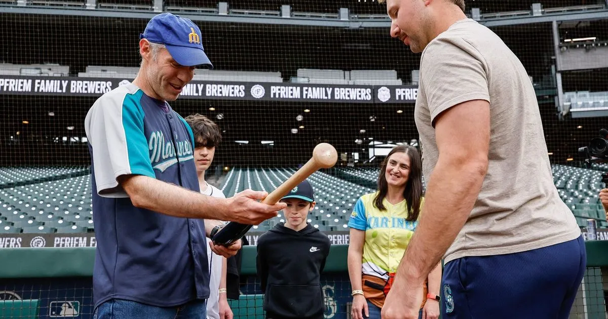 Generosity in the Stands: Fan Catches Cal Raleigh's 60th Home Run Ball and Gives It Away